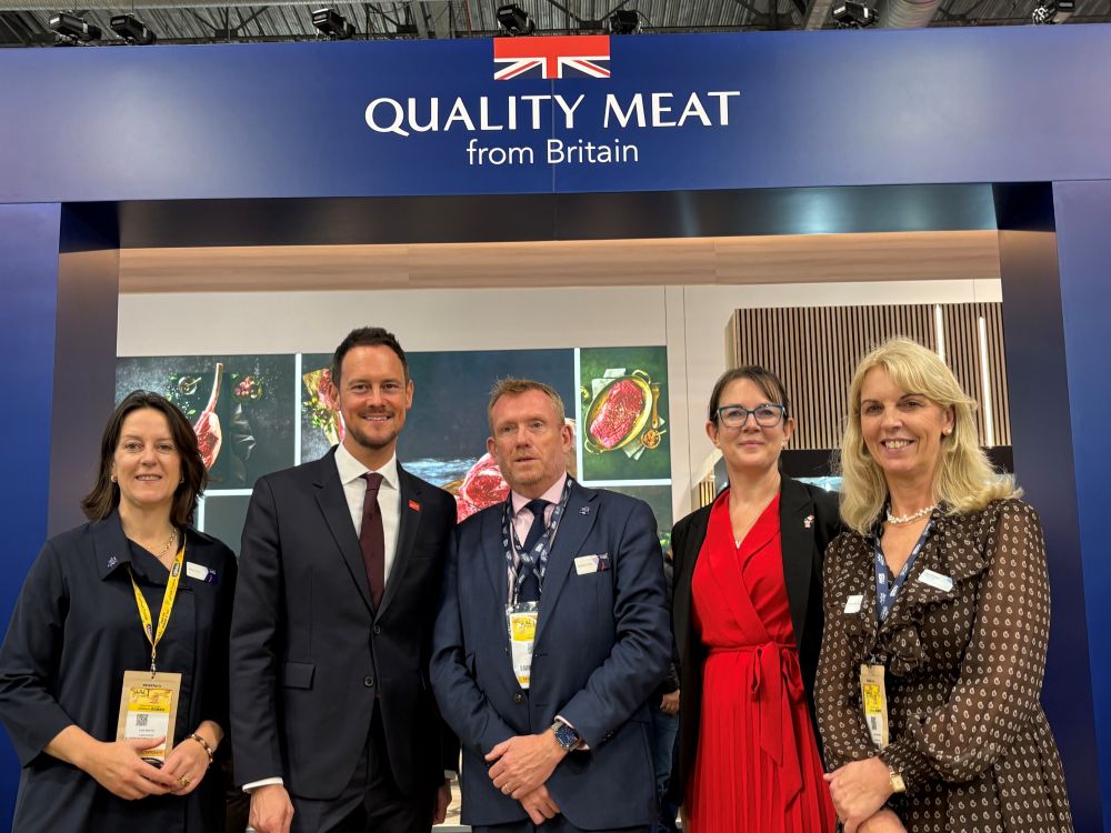 A group of people standing in front of a Quality Meat from Britain stand.